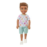 Barbie Chelsea 6 Inch Brunette Boy Doll Wearing Colorful Printed T-Shirt, Blue Shorts & White Shoes for Kids Ages 3 Years Old & Up